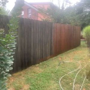 wood fence half dirty and half cleaned